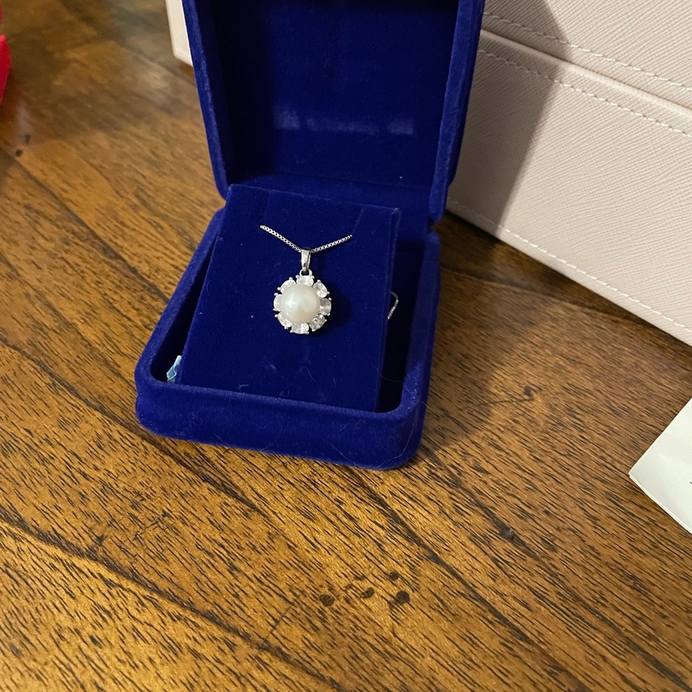 Sterling silver box chain with cultured pearl and cz surround.